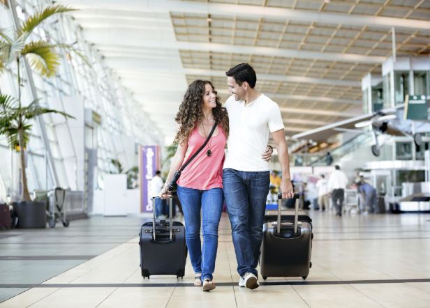 Travelers checking in at a U.S. airport, ensuring safe travels USA